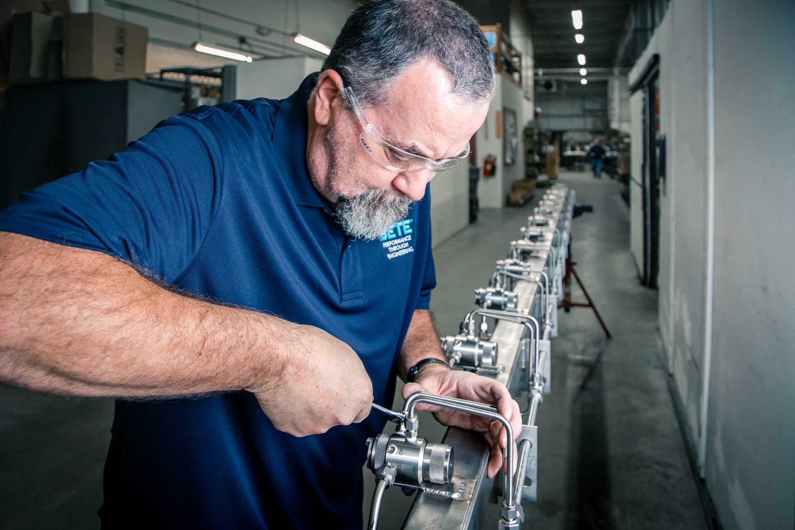A BETE Engineer completes a header assembly with SAM Precision Spray Nozzles