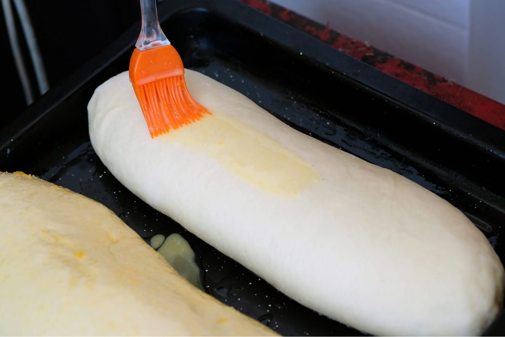 Detail of Orange culinary brush on raw dough.