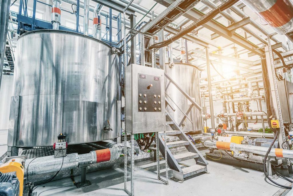 The interior of a chemical processing plant with large emulsion processing tanks